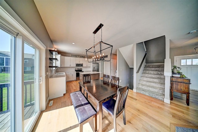509 Grey Slate Dr SW, Cedar Rapids, IA 52404 - dining room featuring light wood-style flooring, a chandelier, stairs, and recessed lighting