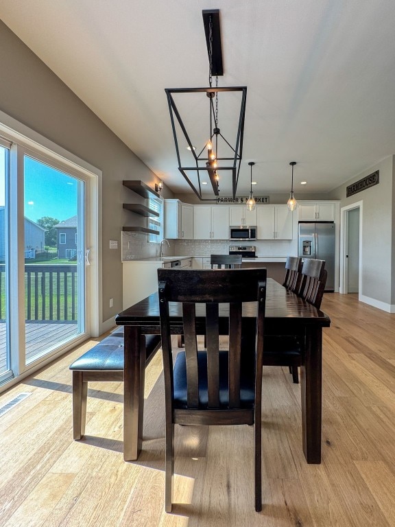 509 Grey Slate Dr SW, Cedar Rapids, IA 52404 - dining area featuring a chandelier and light wood finished floors