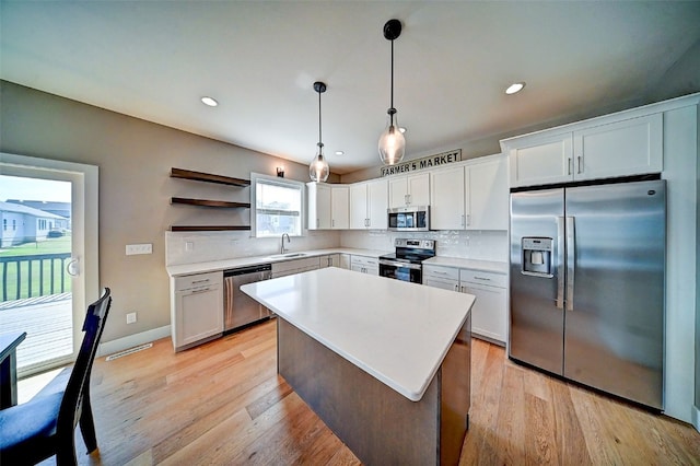 509 Grey Slate Dr SW, Cedar Rapids, IA 52404 - kitchen with stainless steel appliances, backsplash, open shelves, white cabinetry, and recessed lighting