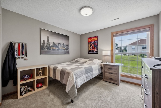 4725 Westchester Dr NE Unit C, Cedar Rapids, IA 52402 - bedroom featuring light carpet and a textured ceiling