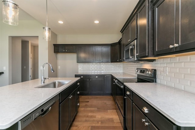 806 Crestview Dr, Solon, IA 52333 - kitchen with appliances with stainless steel finishes, wood finished floors, recessed lighting, decorative light fixtures, and tasteful backsplash