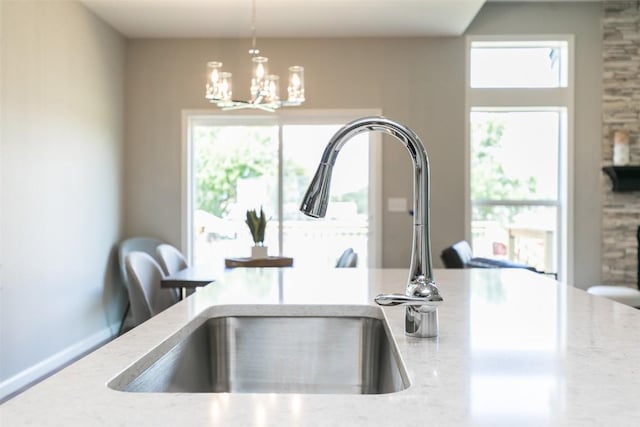 806 Crestview Dr, Solon, IA 52333 - detailed view of a chandelier, light stone countertops, and hanging light fixtures