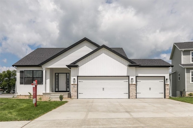 806 Crestview Dr, Solon, IA 52333 - modern inspired farmhouse with an attached garage, concrete driveway, a front lawn, and a shingled roof