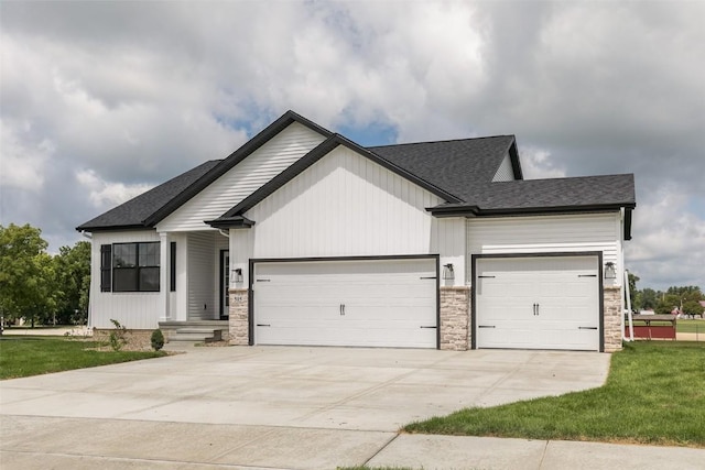 806 Crestview Dr, Solon, IA 52333 - modern inspired farmhouse featuring an attached garage, driveway, a front lawn, stone siding, and a shingled roof