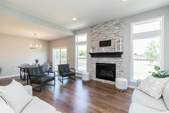 806 Crestview Dr, Solon, IA 52333 - living room with a chandelier, wood finished floors, healthy amount of natural light, and a fireplace