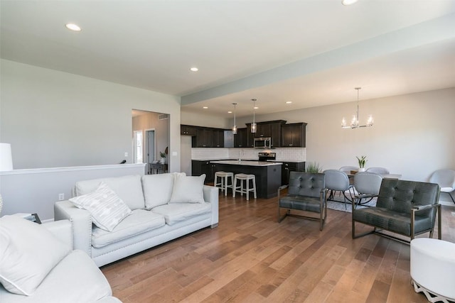 806 Crestview Dr, Solon, IA 52333 - living room with a chandelier, light wood finished floors, and recessed lighting