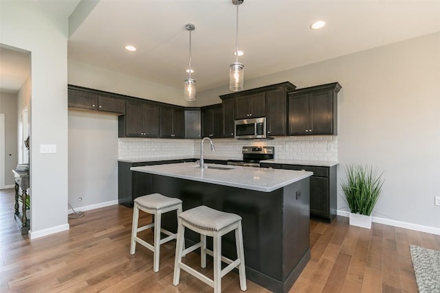 806 Crestview Dr, Solon, IA 52333 - kitchen with stainless steel appliances, decorative backsplash, wood finished floors, and recessed lighting
