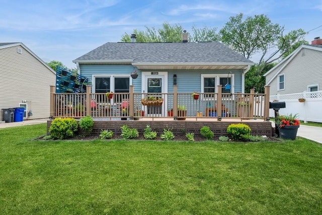 1120 23rd St, Cedar Rapids, IA 52403 - back of property featuring a wooden deck, roof with shingles, and a chimney