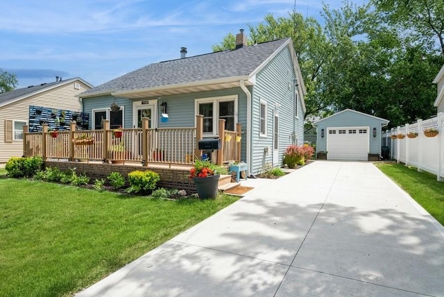 1120 23rd St, Cedar Rapids, IA 52403 - view of front of home with an outdoor structure, a detached garage, a front lawn, concrete driveway, and covered porch