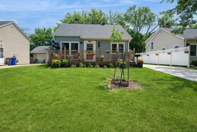 1120 23rd St, Cedar Rapids, IA 52403 - view of front of property with a front yard, a wooden deck, a detached garage, and a chimney