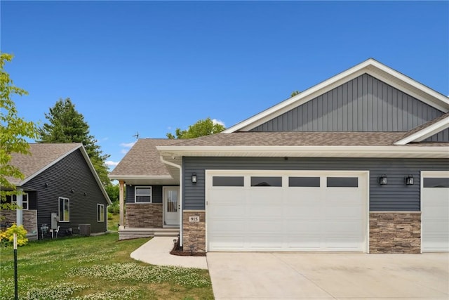 915 Prairie View Dr, West Branch, IA 52358 - craftsman house featuring stone siding, an attached garage, concrete driveway, and roof with shingles