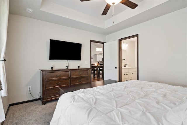 915 Prairie View Dr, West Branch, IA 52358 - bedroom with a tray ceiling, carpet flooring, ensuite bath, and a ceiling fan