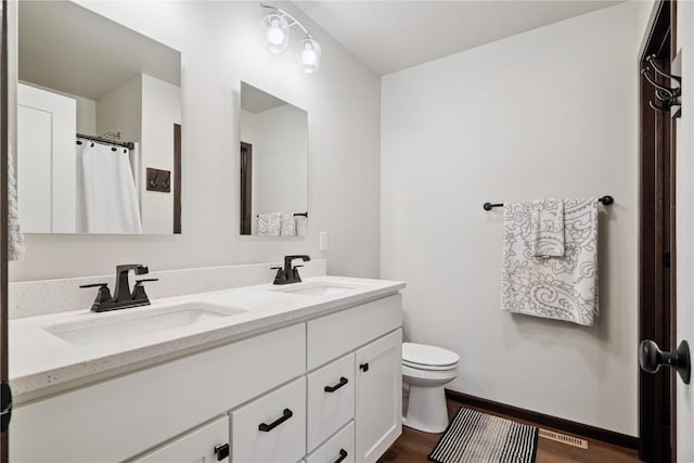 915 Prairie View Dr, West Branch, IA 52358 - full bathroom featuring double vanity and wood finished floors