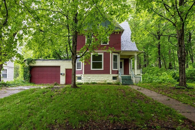 320 College Blvd SW, Mount Vernon, IA 52314 - view of front of home with covered porch, an attached garage, driveway, roof with shingles, and a front lawn