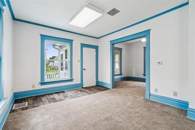 835 10th St SW, Cedar Rapids, IA 52404 - carpeted spare room with ornamental molding, wood finished floors, and a baseboard heating unit