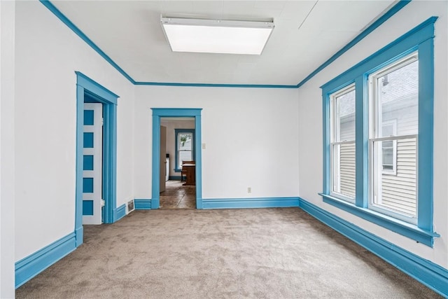 835 10th St SW, Cedar Rapids, IA 52404 - carpeted empty room with baseboards and ornamental molding
