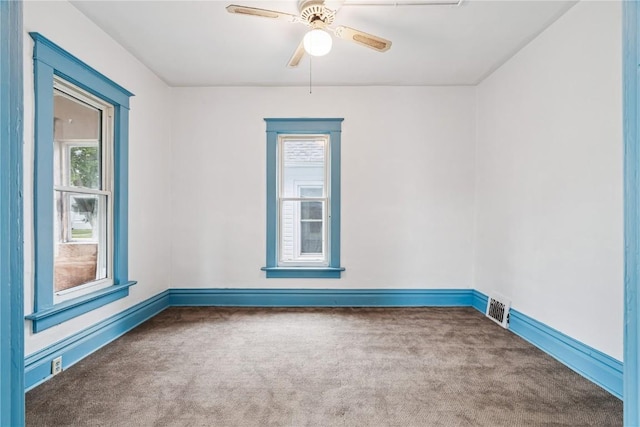 835 10th St SW, Cedar Rapids, IA 52404 - carpeted empty room with baseboards and ceiling fan