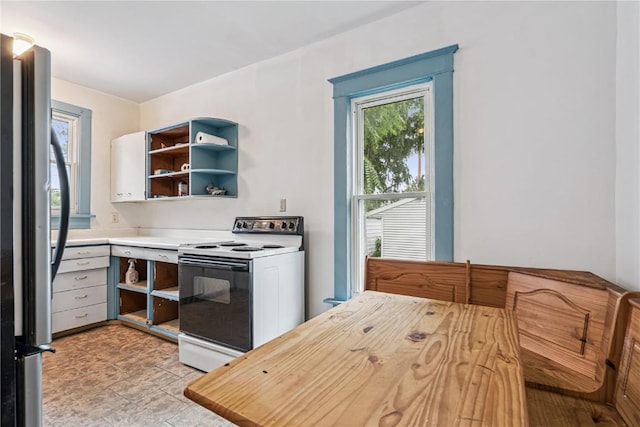 835 10th St SW, Cedar Rapids, IA 52404 - kitchen featuring white range with electric cooktop, open shelves, and freestanding refrigerator