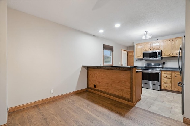 5315 E Ave NW, Cedar Rapids, IA 52405 - kitchen with stainless steel appliances, dark countertops, recessed lighting, and light wood-type flooring