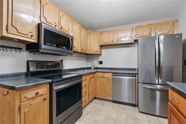 5315 E Ave NW, Cedar Rapids, IA 52405 - kitchen featuring stainless steel appliances, dark countertops, and light tile patterned floors