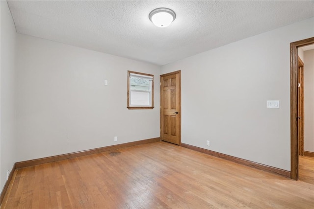 5315 E Ave NW, Cedar Rapids, IA 52405 - unfurnished room with light wood-style flooring and a textured ceiling