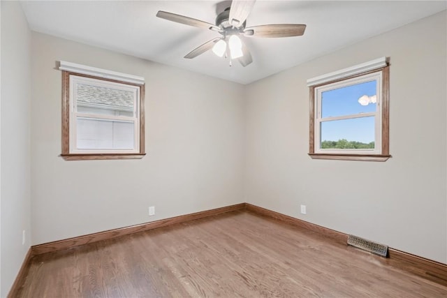 5315 E Ave NW, Cedar Rapids, IA 52405 - empty room with plenty of natural light, wood finished floors, and a ceiling fan