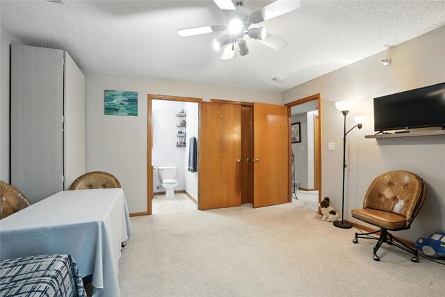 414 W Side Dr, Iowa City, IA 52246 - bedroom with light carpet, a textured ceiling, ensuite bath, and ceiling fan