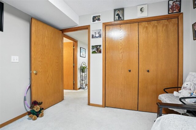 414 W Side Dr, Iowa City, IA 52246 - bedroom featuring light carpet and a closet