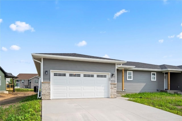 3880 Quail Trail Dr, Marion, IA 52302 - single story home with driveway, stone siding, and an attached garage
