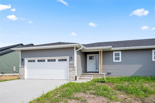 3880 Quail Trail Dr, Marion, IA 52302 - view of front of house featuring an attached garage, driveway, stone siding, and roof with shingles