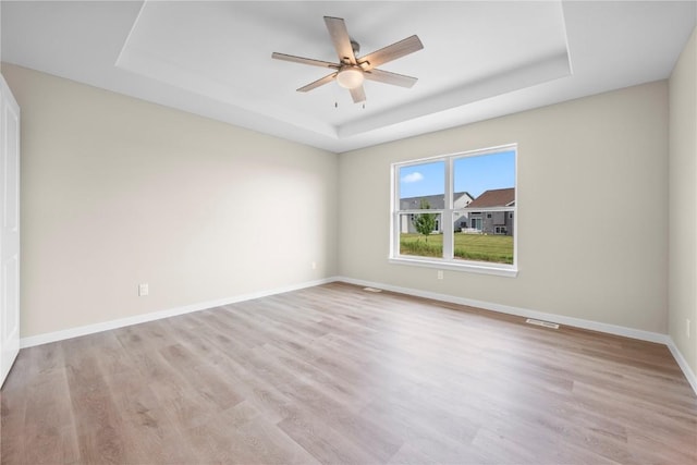 3880 Quail Trail Dr, Marion, IA 52302 - empty room with a raised ceiling, ceiling fan, and wood finished floors