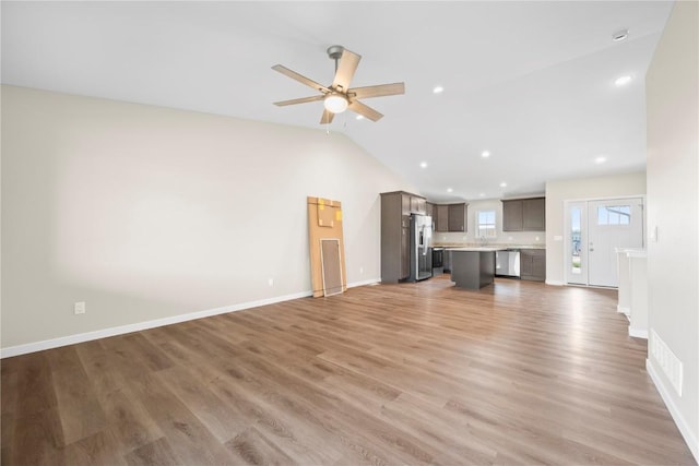3880 Quail Trail Dr, Marion, IA 52302 - unfurnished living room featuring vaulted ceiling, light wood-type flooring, a ceiling fan, and recessed lighting