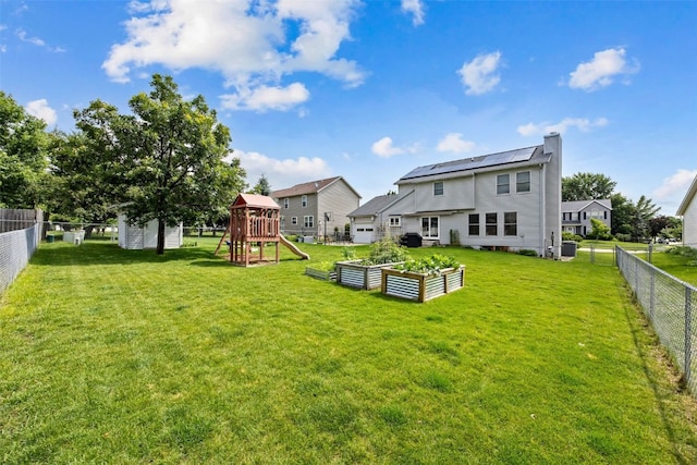 1720 Charleston Dr, Marion, IA 52302 - back of house featuring a playground, a garden, a fenced backyard, and a chimney