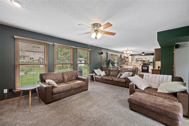1720 Charleston Dr, Marion, IA 52302 - living area featuring a ceiling fan, carpet flooring, a textured ceiling, and a chandelier