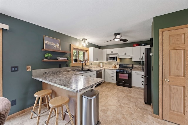 1720 Charleston Dr, Marion, IA 52302 - kitchen with stainless steel appliances, a peninsula, white cabinets, a ceiling fan, and a breakfast bar area