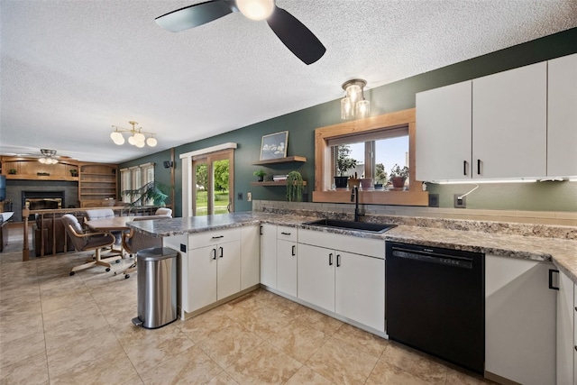 1720 Charleston Dr, Marion, IA 52302 - kitchen featuring dishwasher, a ceiling fan, a textured ceiling, a fireplace, and white cabinetry