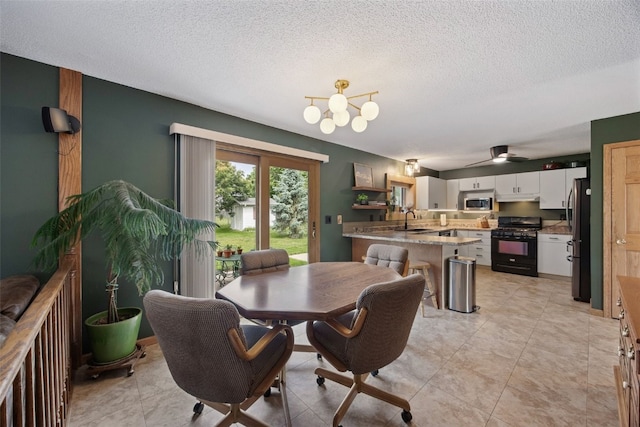 1720 Charleston Dr, Marion, IA 52302 - dining area featuring a textured ceiling, a chandelier, and ceiling fan