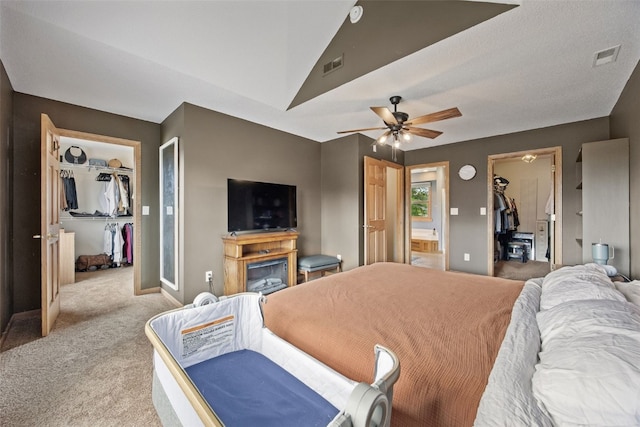 1720 Charleston Dr, Marion, IA 52302 - bedroom with a spacious closet, a closet, light colored carpet, connected bathroom, and ceiling fan