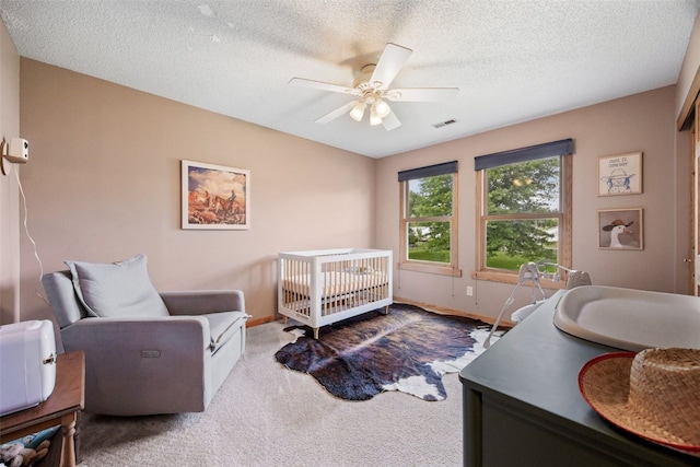 1720 Charleston Dr, Marion, IA 52302 - carpeted bedroom with a ceiling fan, a textured ceiling, and a crib