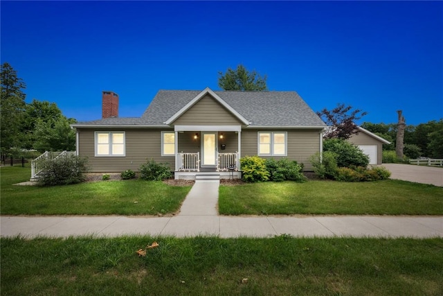 115 3rd St NE, Mount Vernon, IA 52314 - bungalow-style home featuring a porch, a chimney, a front yard, and a garage