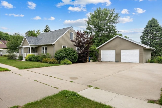 115 3rd St NE, Mount Vernon, IA 52314 - view of side of home with a garage, an outdoor structure, a yard, and roof with shingles
