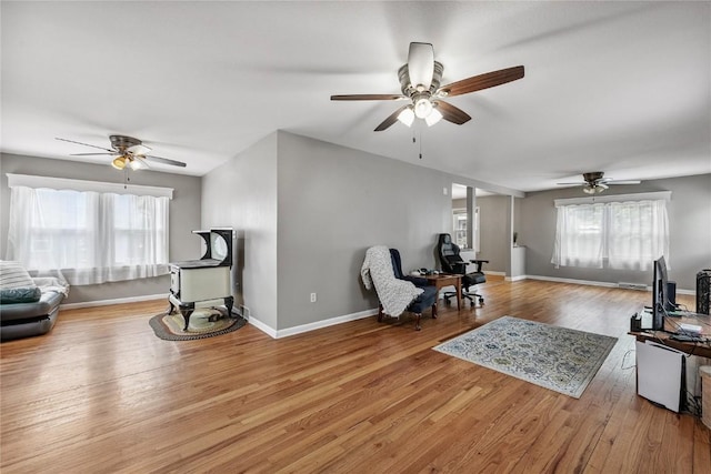 115 3rd St NE, Mount Vernon, IA 52314 - living area with a ceiling fan, plenty of natural light, and wood finished floors
