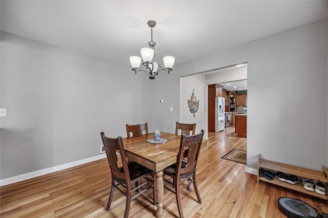 115 3rd St NE, Mount Vernon, IA 52314 - dining room featuring a chandelier and light wood-style floors