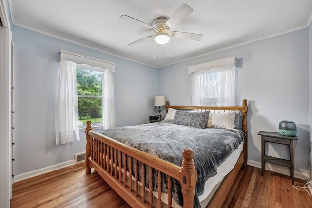 115 3rd St NE, Mount Vernon, IA 52314 - bedroom with ornamental molding, wood finished floors, and ceiling fan
