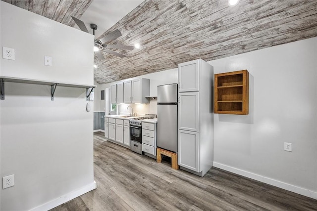 115 3rd St NE, Mount Vernon, IA 52314 - kitchen with stainless steel appliances, ceiling fan, wood ceiling, vaulted ceiling, and wood finished floors