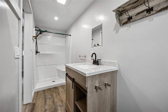 115 3rd St NE, Mount Vernon, IA 52314 - full bathroom with a shower, wood finished floors, vanity, and recessed lighting