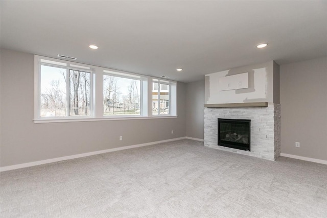 5750 Meadow Grass Cir SE, Cedar Rapids, IA 52403 - unfurnished living room featuring carpet floors, healthy amount of natural light, a fireplace, and recessed lighting
