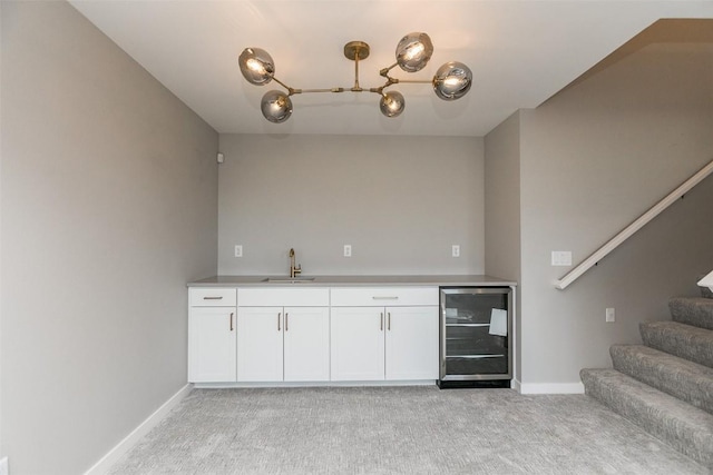 5750 Meadow Grass Cir SE, Cedar Rapids, IA 52403 - indoor wet bar with beverage cooler, light colored carpet, stairway, and a chandelier