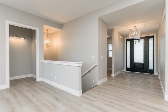 5750 Meadow Grass Cir SE, Cedar Rapids, IA 52403 - foyer featuring a chandelier and wood finished floors