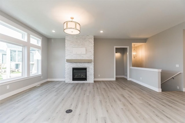 5750 Meadow Grass Cir SE, Cedar Rapids, IA 52403 - unfurnished living room featuring wood finished floors, a stone fireplace, and recessed lighting
